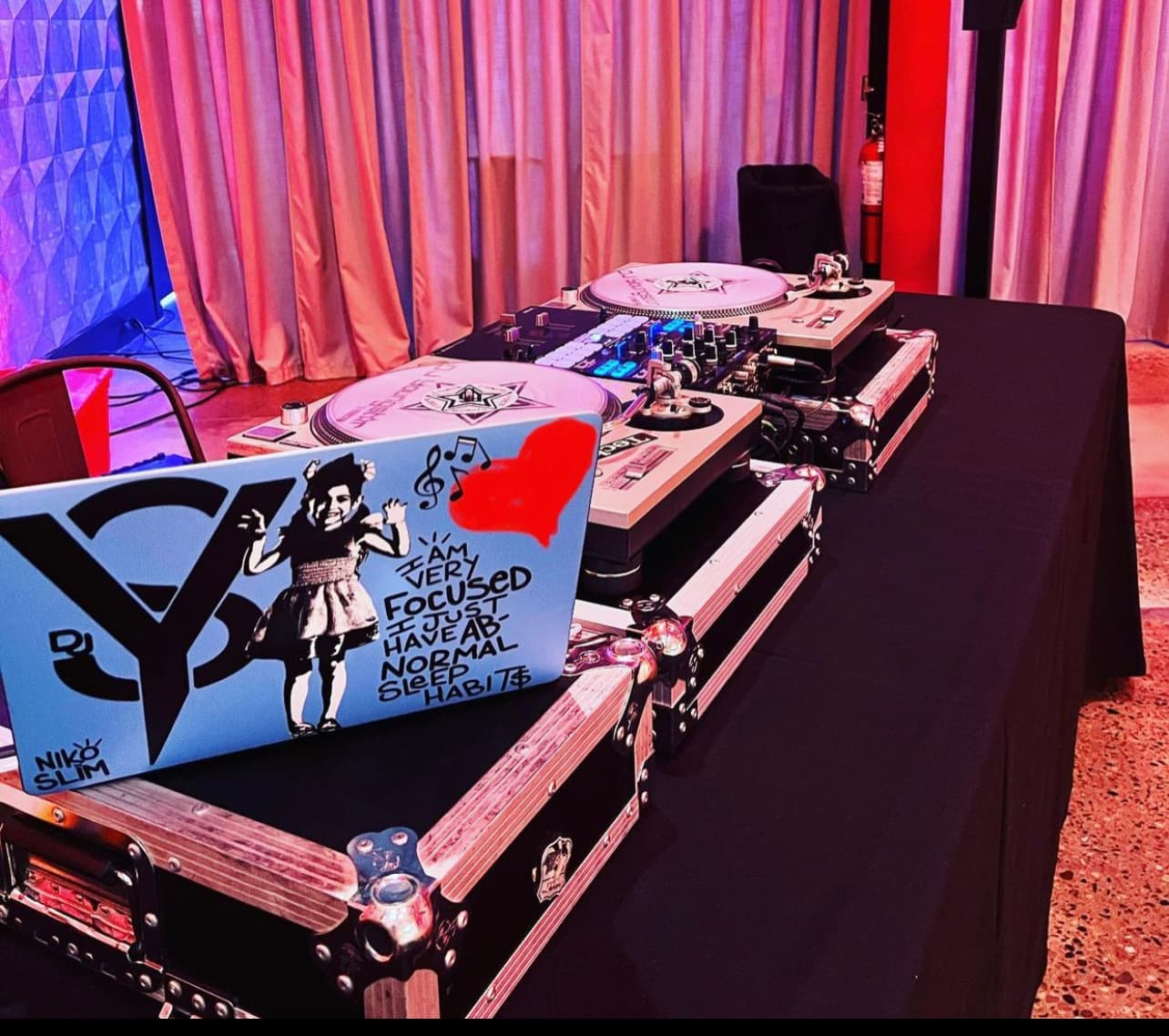 DJ YS turntables and laptop set up for a party